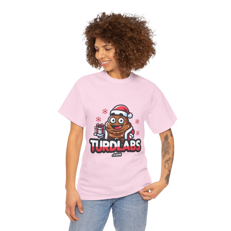 Humorous Christmas poop emoji shirt with Santa hat and gifts, worn by smiling tattooed person.